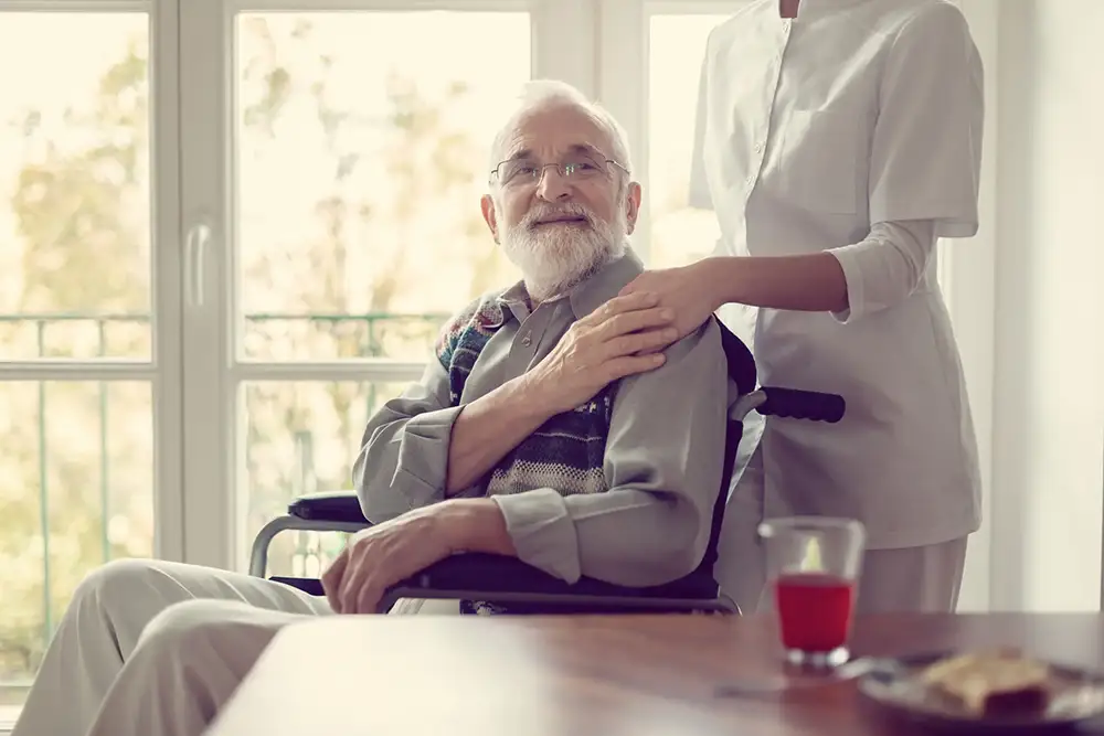 Senior man in a wheelchair with his caregiver