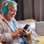 Senior man listening to a podcast from his phone