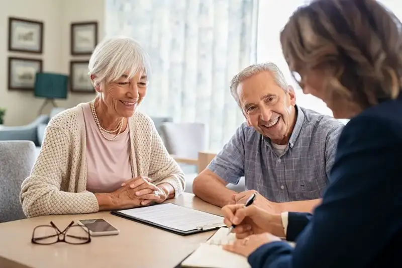 Elderly couple talking with an elder law attorney