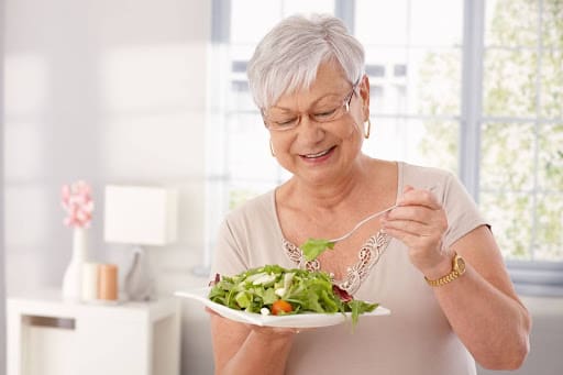 A senior woman enjoys a nourishing salad