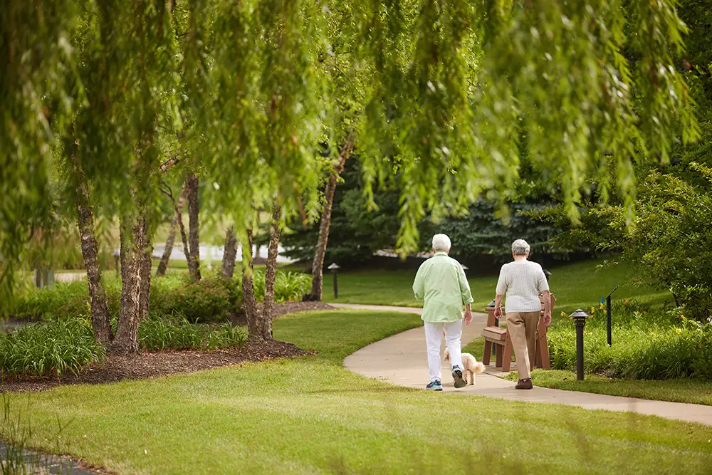 Two residents walking in the park.