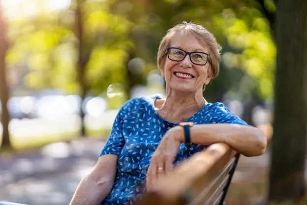 senior woman sitting on a park bench